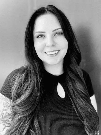 A woman with long hair and a black shirt.